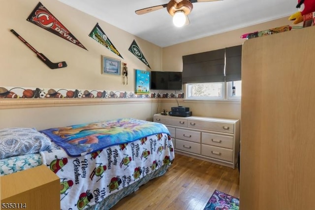 bedroom featuring wood finished floors and ceiling fan
