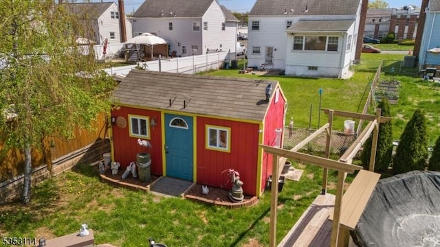 view of outdoor structure featuring an outbuilding and a fenced backyard