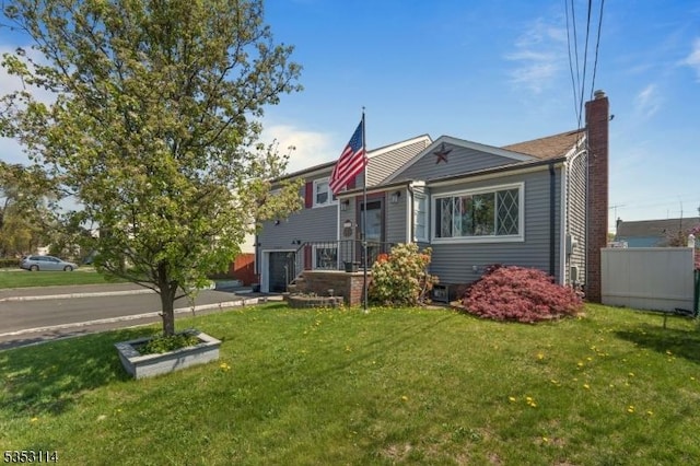 tri-level home featuring a chimney and a front yard
