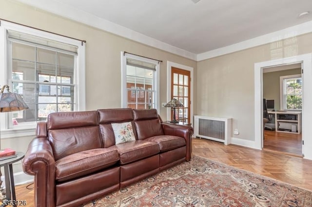 living room featuring baseboards and radiator heating unit