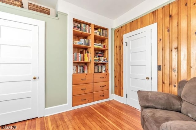 sitting room featuring baseboards and light wood finished floors