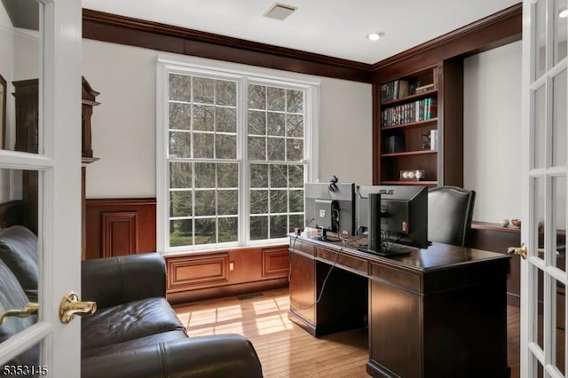office area featuring visible vents, ornamental molding, built in features, and plenty of natural light