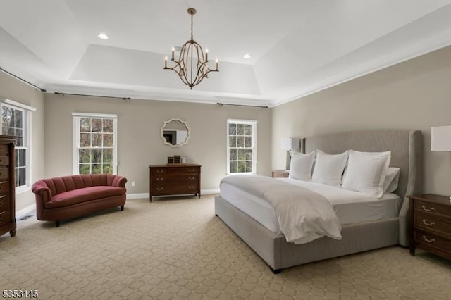 bedroom with an inviting chandelier, multiple windows, a tray ceiling, and recessed lighting