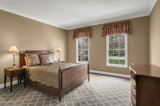 carpeted bedroom with baseboards, ornamental molding, and multiple windows
