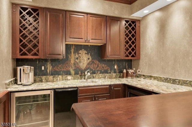 bar with indoor wet bar, a sink, backsplash, and beverage cooler