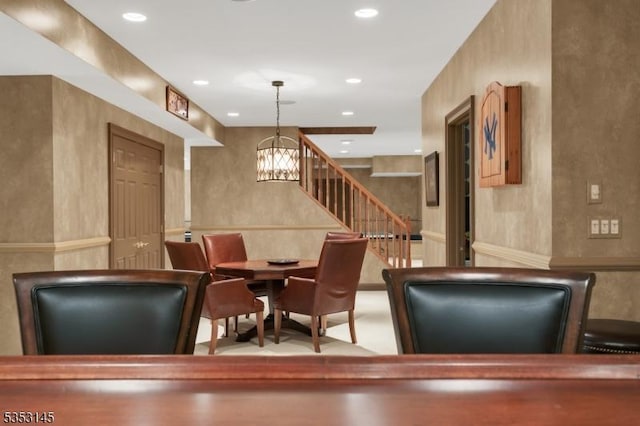 dining space with recessed lighting, stairs, and a chandelier