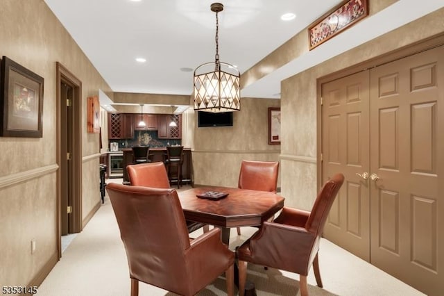 dining area with recessed lighting, a chandelier, and light carpet