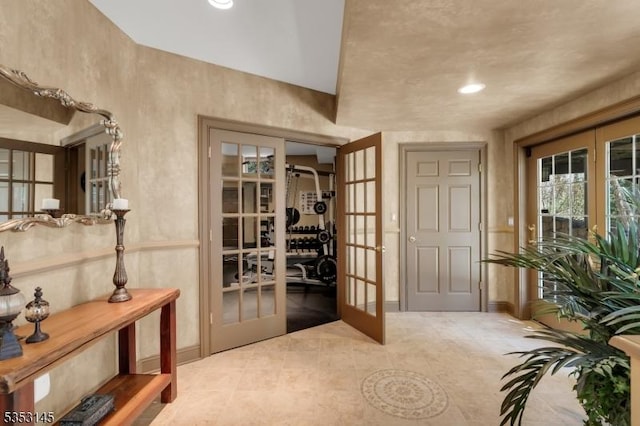 wine area with baseboards, tile patterned flooring, and french doors