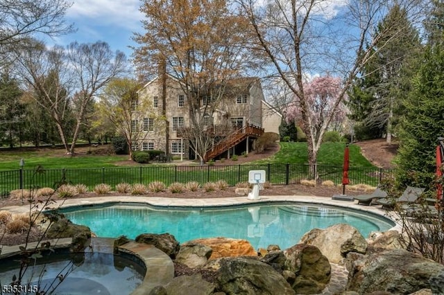 view of pool featuring a fenced backyard, a fenced in pool, a lawn, an in ground hot tub, and stairway