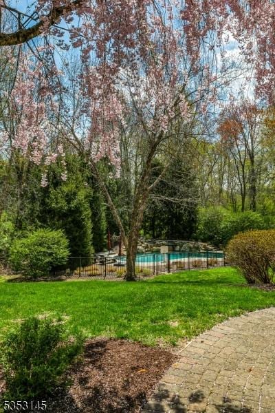 view of yard featuring a fenced in pool and fence