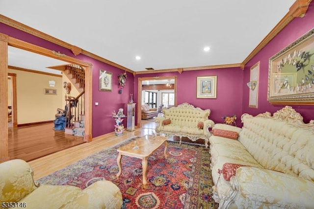 living room featuring recessed lighting, ornamental molding, wood finished floors, and stairway