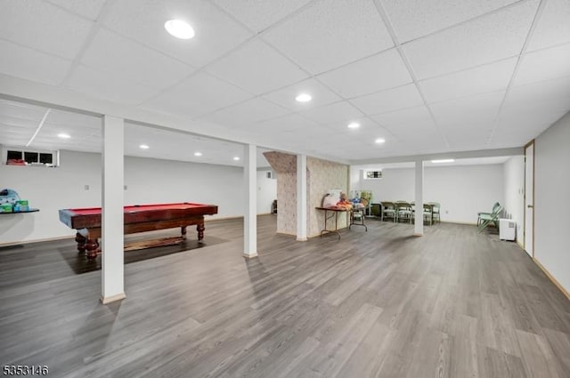 finished below grade area with wood finished floors, baseboards, recessed lighting, a paneled ceiling, and billiards