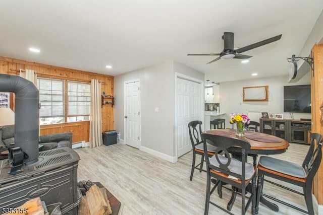 dining room with baseboards, recessed lighting, a baseboard heating unit, a ceiling fan, and light wood finished floors