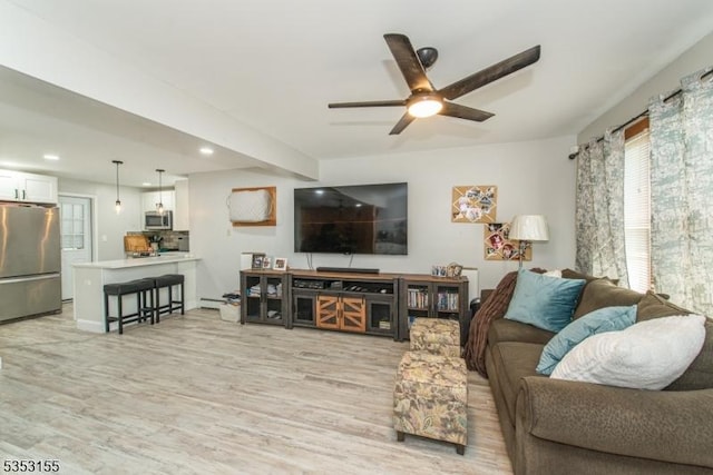 living room featuring recessed lighting, a ceiling fan, light wood-style flooring, and a baseboard heating unit