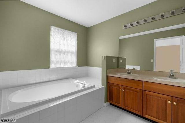 bathroom with a sink, a bath, tile patterned flooring, and double vanity