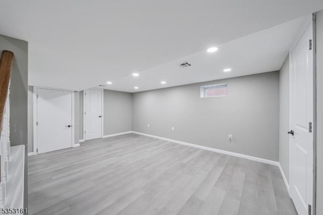 basement with recessed lighting, baseboards, visible vents, and light wood-type flooring