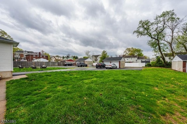 view of yard featuring fence and a residential view