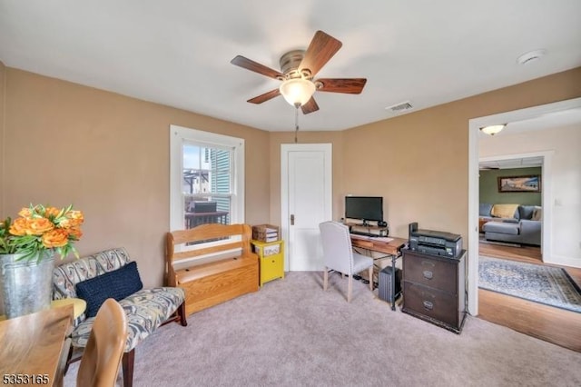 home office with visible vents, ceiling fan, and carpet floors