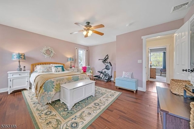 bedroom featuring baseboards, visible vents, ceiling fan, and dark wood-type flooring
