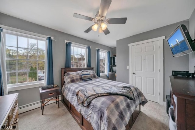 bedroom featuring ceiling fan, light carpet, and baseboards