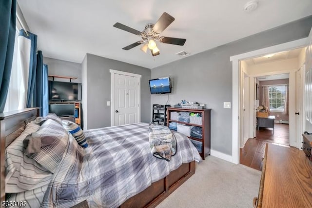 bedroom with baseboards, visible vents, ceiling fan, and carpet