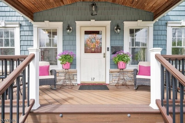 view of exterior entry with covered porch