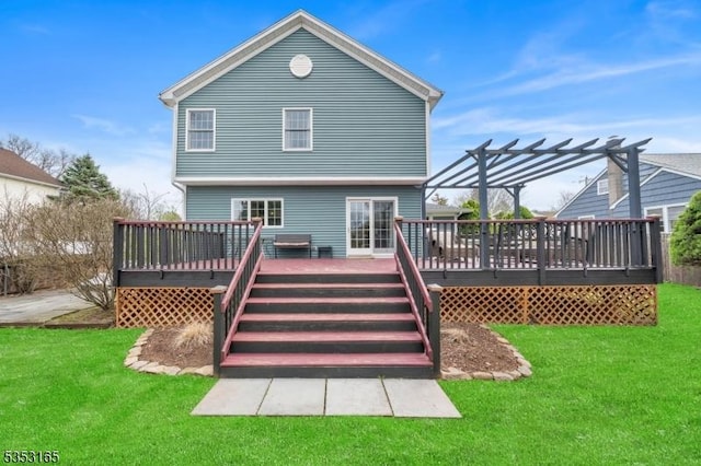 rear view of house with a deck, a lawn, and a pergola