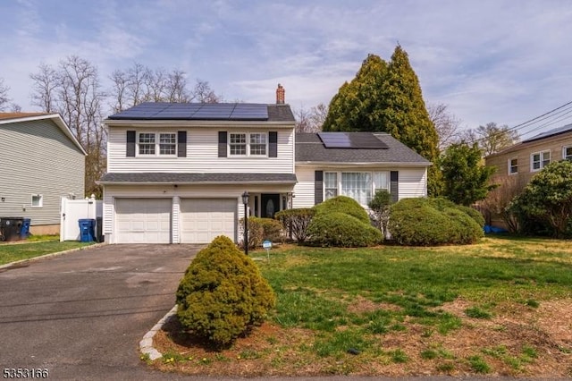 1077 Allenwood Dr, Plainfield City, NJ 07060 - tri-level home with a garage, a front lawn, a chimney, and solar panels