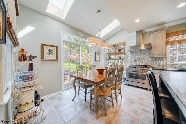 dining area featuring vaulted ceiling with skylight, baseboards, light tile patterned floors, and recessed lighting