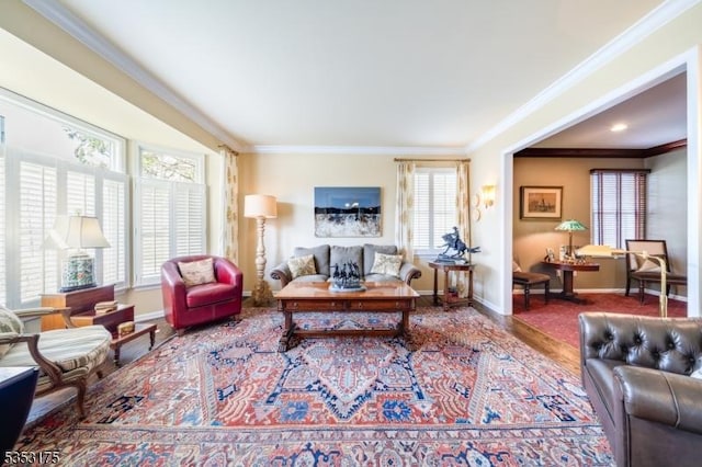 living area with baseboards, ornamental molding, and a healthy amount of sunlight