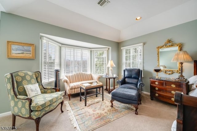 sitting room featuring baseboards, carpet flooring, lofted ceiling, and visible vents