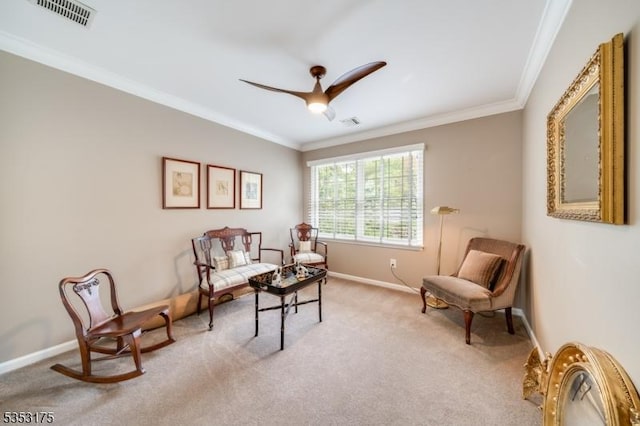 sitting room with visible vents, ornamental molding, baseboards, and a ceiling fan