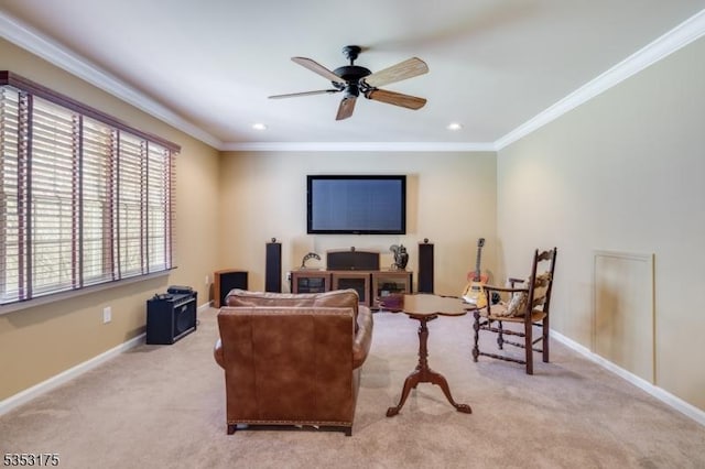 living room featuring baseboards, ornamental molding, a ceiling fan, and light carpet