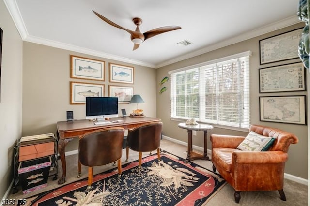carpeted office space featuring baseboards, ornamental molding, a ceiling fan, and visible vents