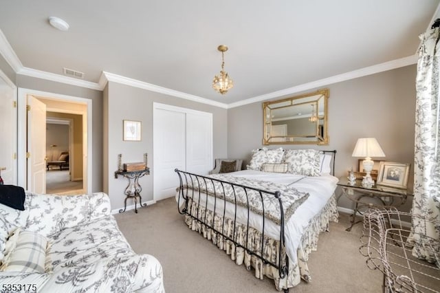 carpeted bedroom with visible vents, ornamental molding, a closet, baseboards, and a chandelier