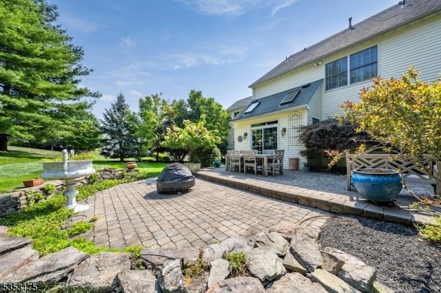 view of patio featuring outdoor dining space and an outdoor fire pit