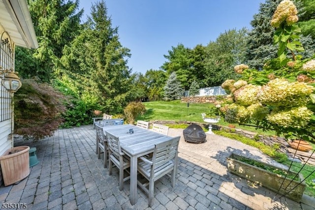 view of patio with outdoor dining area and an outdoor fire pit
