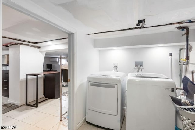 laundry room featuring tile patterned floors, laundry area, an AC wall unit, and washer and dryer