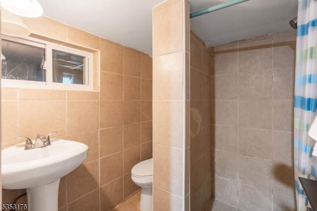 full bathroom with toilet, tile walls, and a tile shower