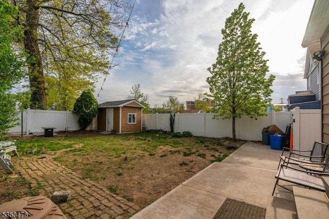 view of yard featuring a fenced backyard, an outbuilding, a patio area, and a shed