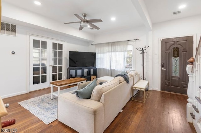 living room featuring a ceiling fan, visible vents, french doors, and wood finished floors