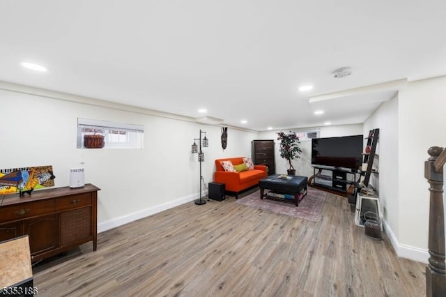 living room featuring recessed lighting, light wood-style flooring, and baseboards