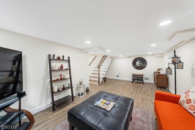 living room with stairway, recessed lighting, and light wood-type flooring