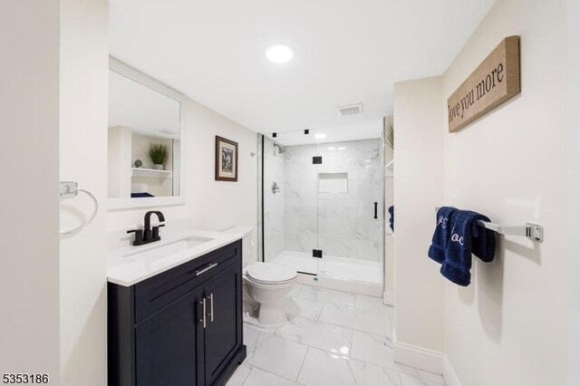 full bathroom with vanity, marble finish floor, toilet, baseboards, and a marble finish shower