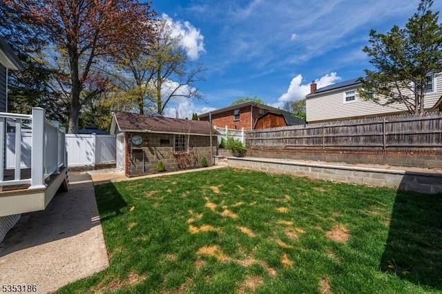 view of yard featuring an outdoor structure and a fenced backyard