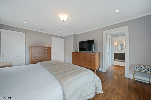 bedroom featuring dark wood finished floors, ornamental molding, recessed lighting, baseboards, and ensuite bathroom