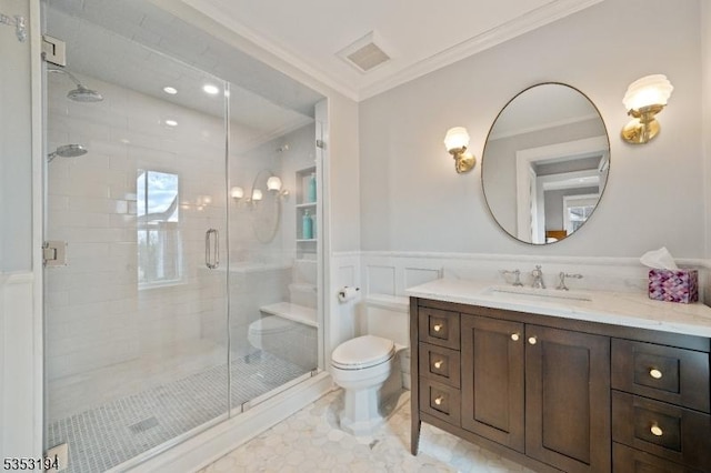full bath with toilet, crown molding, a shower stall, vanity, and wainscoting