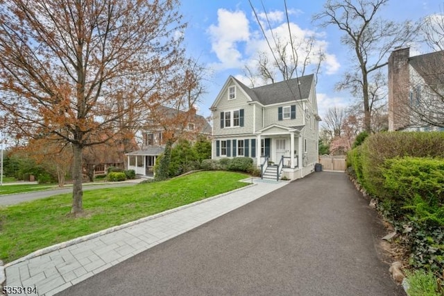view of front of home with a front yard and driveway