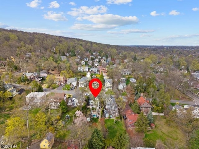 aerial overview of property's location featuring a forest and nearby suburban area