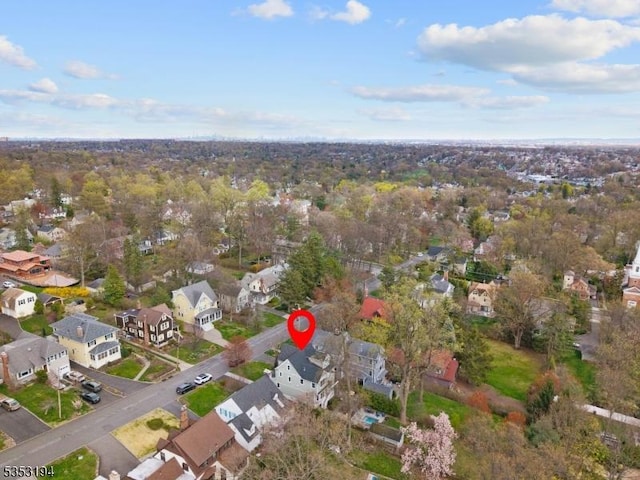 aerial view of property and surrounding area with nearby suburban area